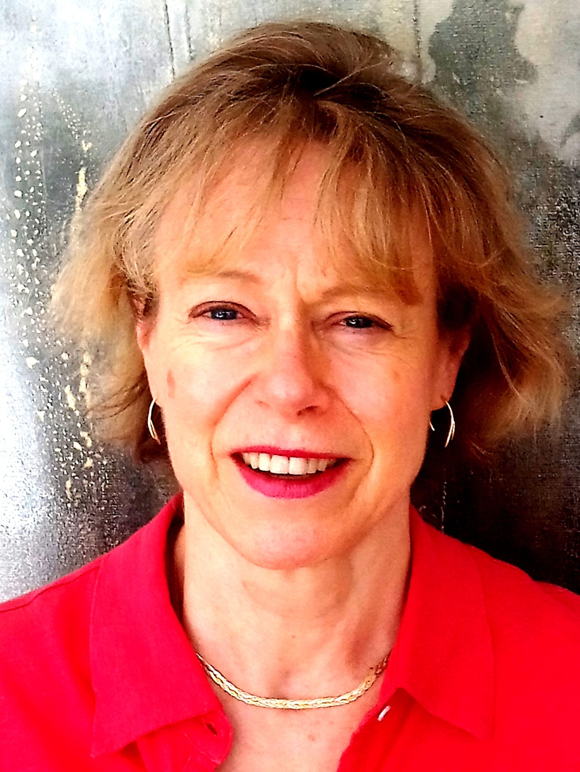 a woman in a red shirt is smiling