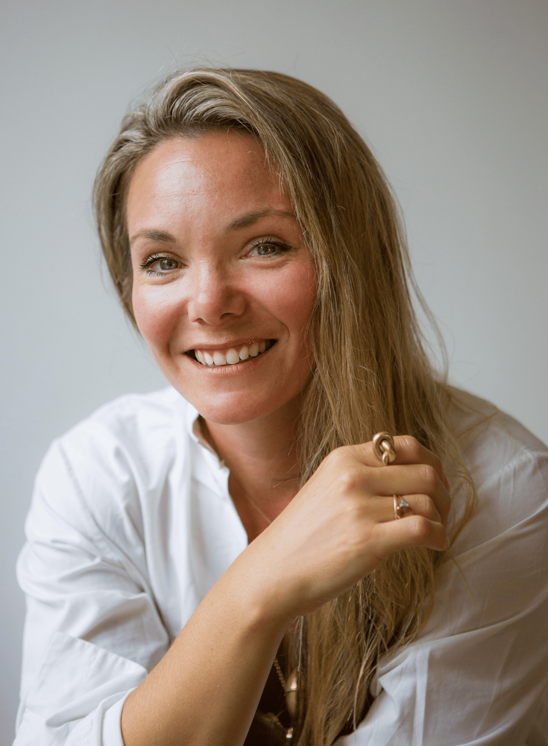 Headshot of Hannah Kidd, a fair skinned woman in her 40s with long blonde hair, wearing a white shirt.